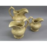 Graduated set of three 19th Century English salt glazed relief moulded jugs, the tallest 8.25ins