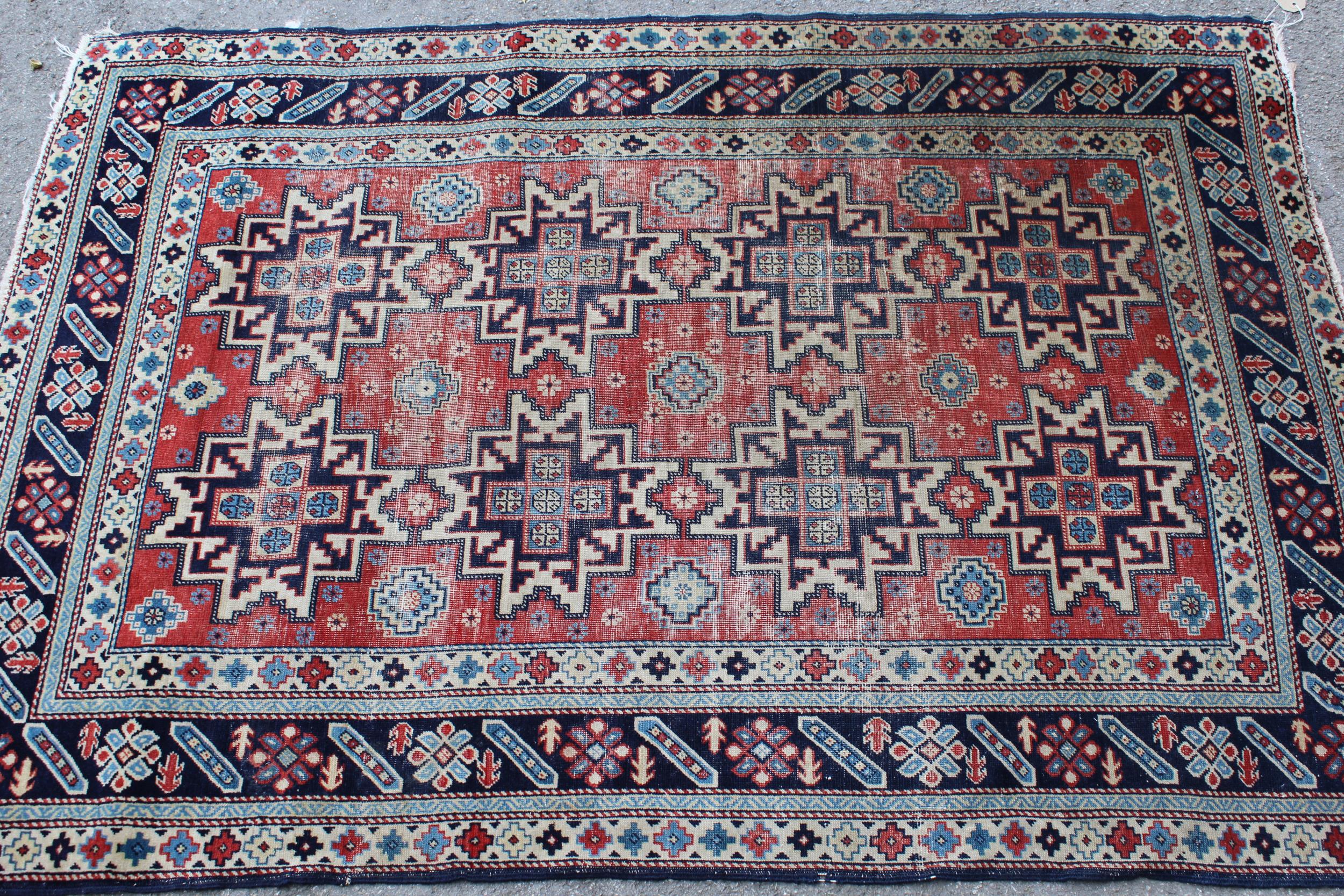 Shirvan rug with eight medallion design on a brick red field with borders, 4ft 10ins x 3ft 8ins