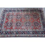 Shirvan rug with eight medallion design on a brick red field with borders, 4ft 10ins x 3ft 8ins