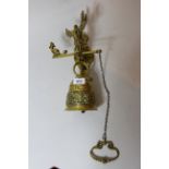 Ornate cast brass bell with wall mount