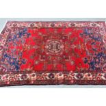 Tabriz rug with a medallion design on a red ground, with blue corner designs and borders, 6ft x