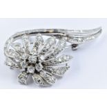 Unmarked high carat white metal and diamond set floral design brooch of Art Deco design,