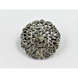 Unmarked white metal and rose cut diamond set flower head brooch, approximately 23m diameter