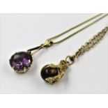 14ct Gold mounted amethyst pendant suspended from an 18ct gold chain and a 9ct gold tigers eye set