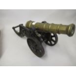 Cast iron and brass barrelled model of a canon 47cms long