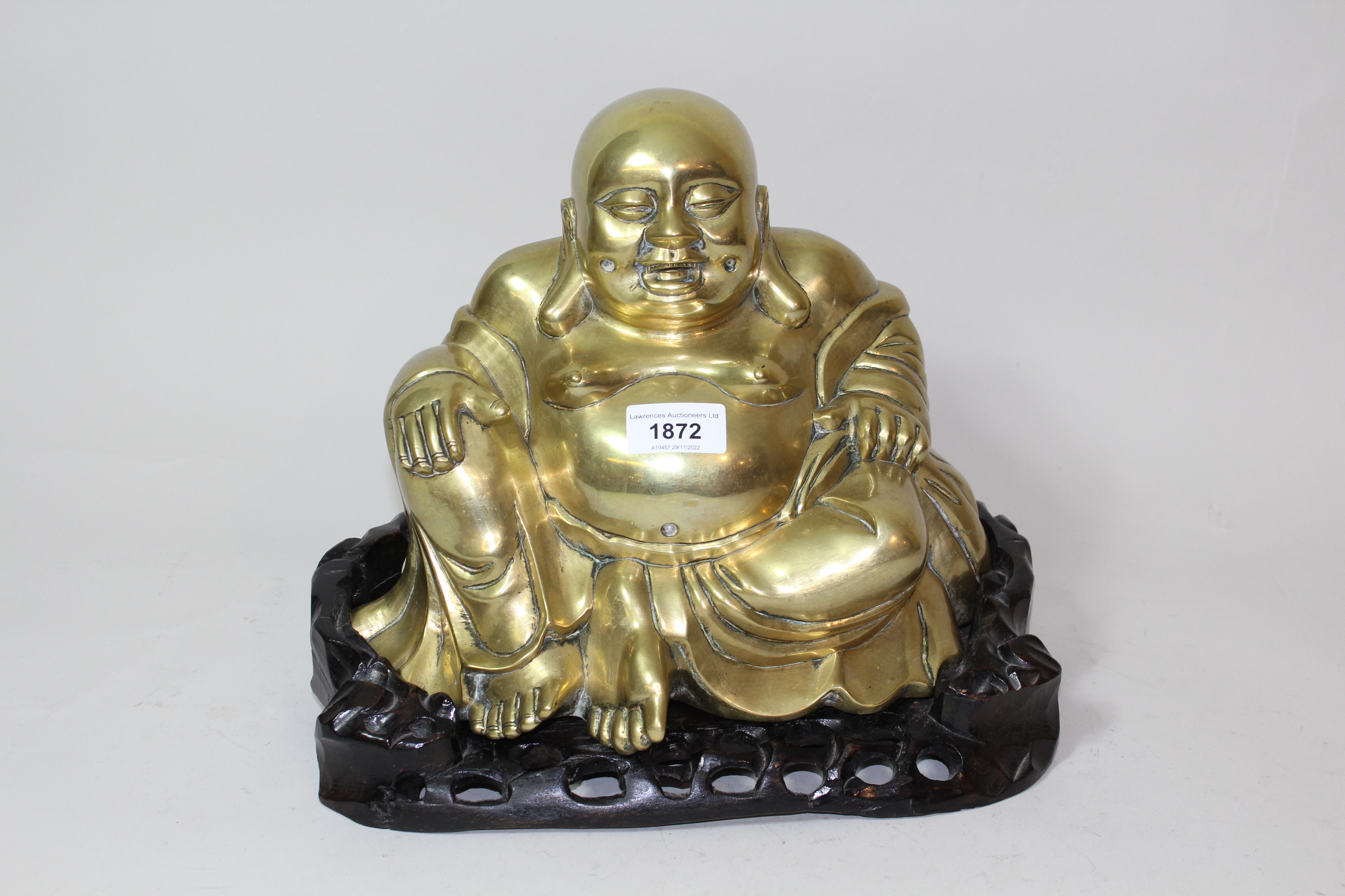 Late 19th / early 20th Century Chinese gilt bronze figure of seated buddha, on a carved hardwood