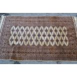 Small Pakistan rug of Turkoman design with three rows of gols on a beige ground with borders, 5ft