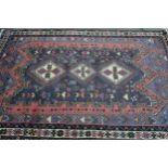 Modern Persian Belouch style carpet with a triple hooked medallion, floral and bird design in shades