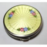 Sterling silver yellow translucent enamel and floral decorated compact, the hinged lid enclosing a