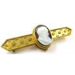 Victorian unmarked yellow metal and cameo set bar brooch of Etruscan design, the central cameo