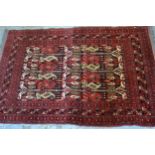 Belouch rug with a central panel design and multiple borders with red ground, 4ft 8ins x 3ft 2ins