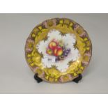 Royal Worcester cabinet plate, painted with fruits by R. Lewis, within a yellow, pink and gilt