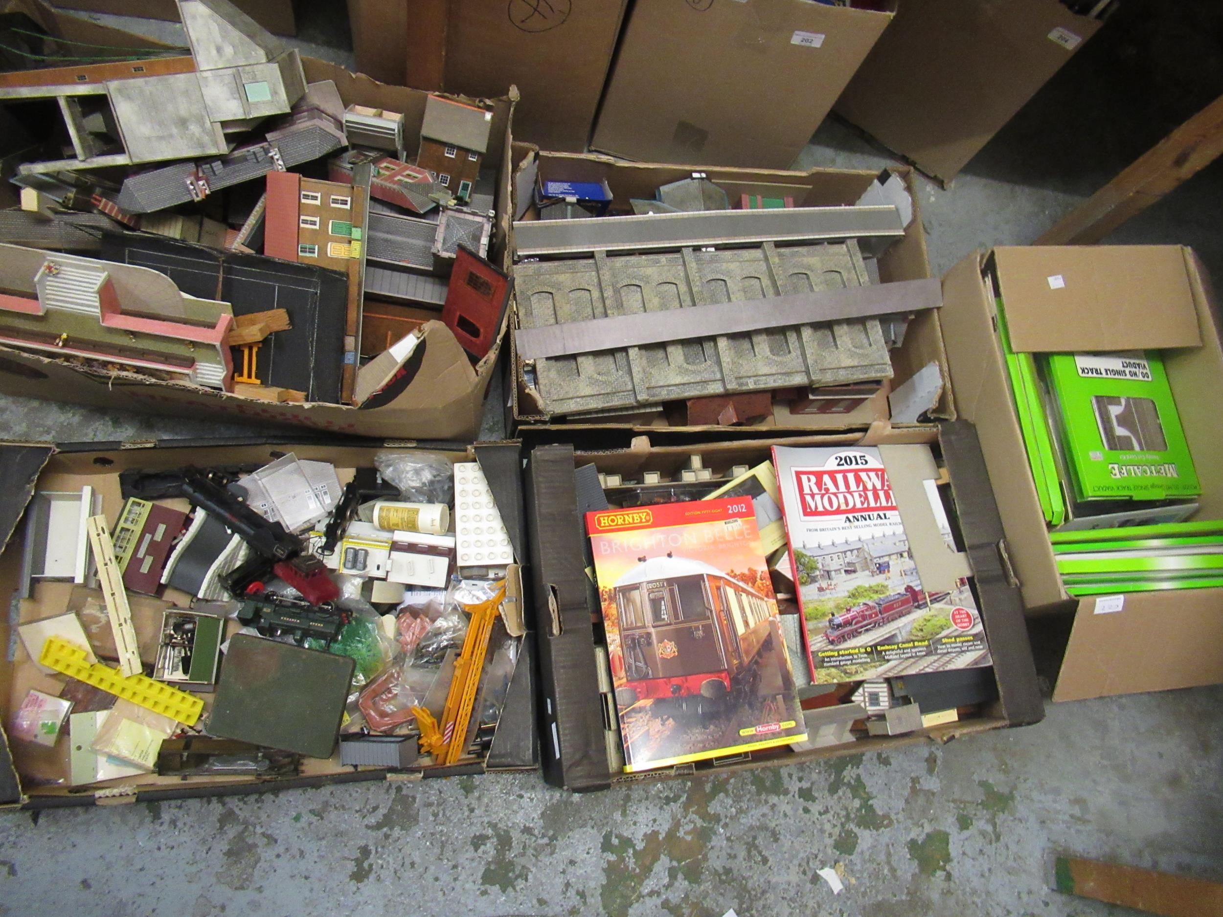 Four boxes containing a large collection of various railway buildings, magazines, engines and