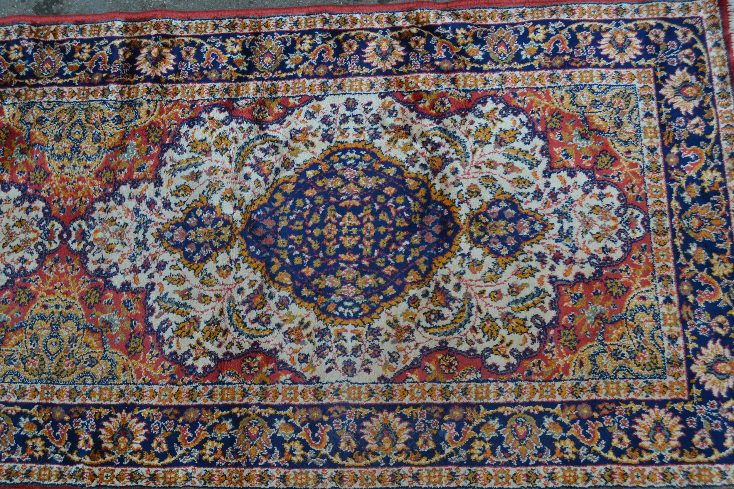 Modern machine woven rug of Persian design with a triple medallion on a rose ground with borders, - Image 2 of 2