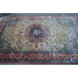 Indo Persian rug with a medallion and all-over stylised floral design in shades of deep blue, pink