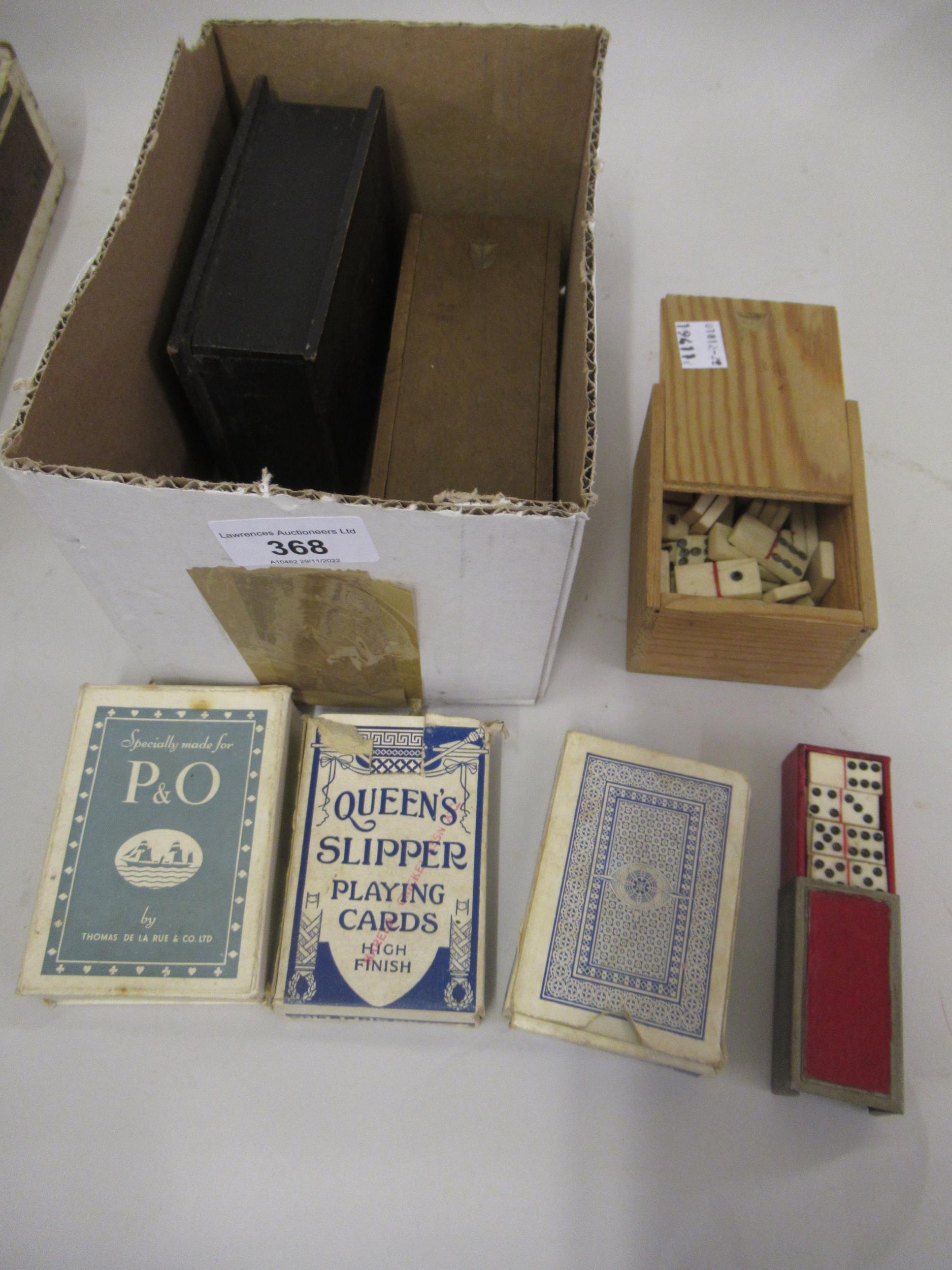 Two boxed sets of bone and ebony dominoes, various packs of cards and a miniature boxed set of