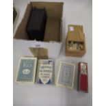 Two boxed sets of bone and ebony dominoes, various packs of cards and a miniature boxed set of
