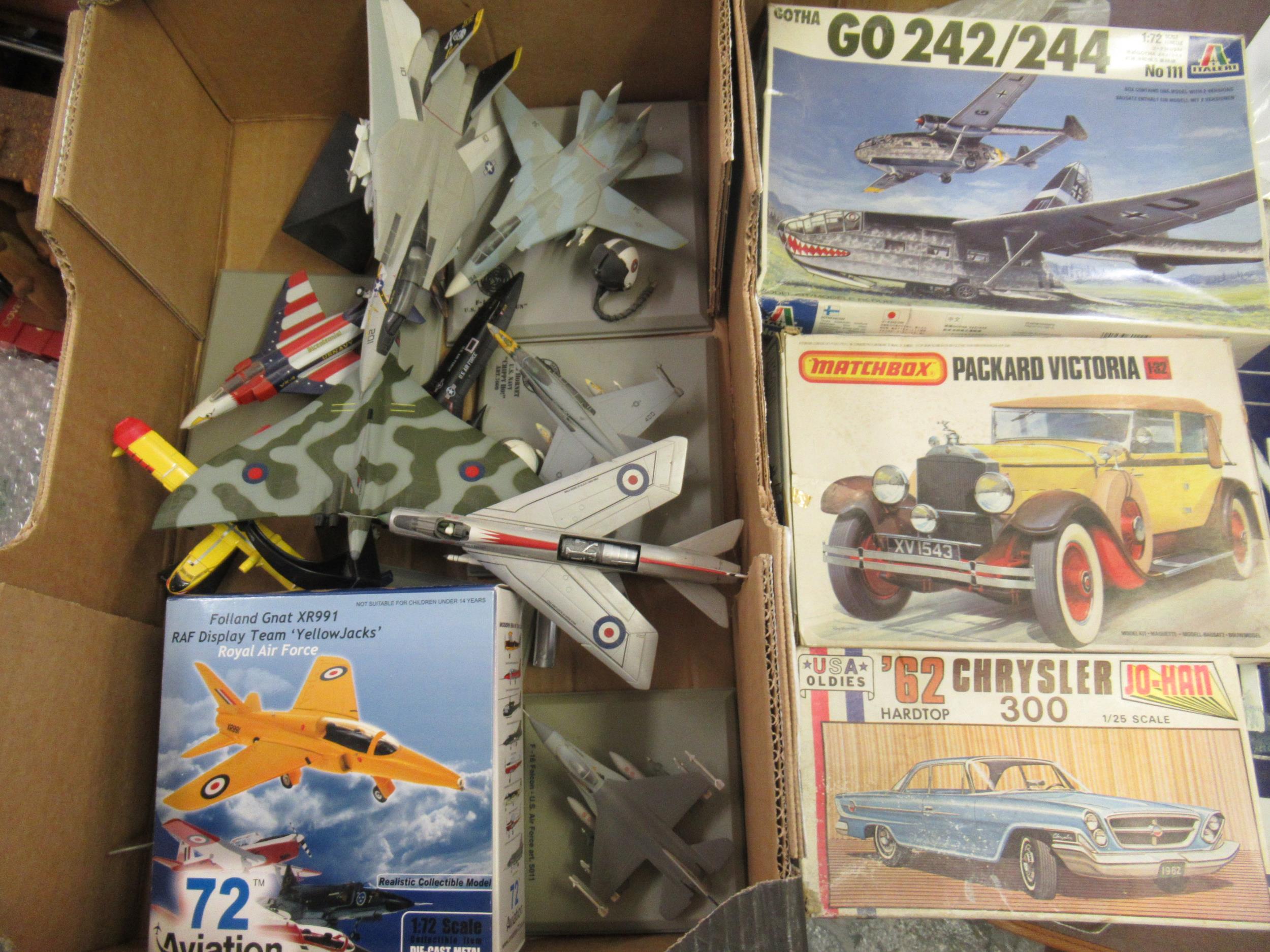 Three boxed model kits, including Italeri, Matchbox and Jo-Han and a box of diecast metal model jets