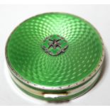 Small Continental silver gilt and green translucent enamel compact, the hinged lid enclosing a