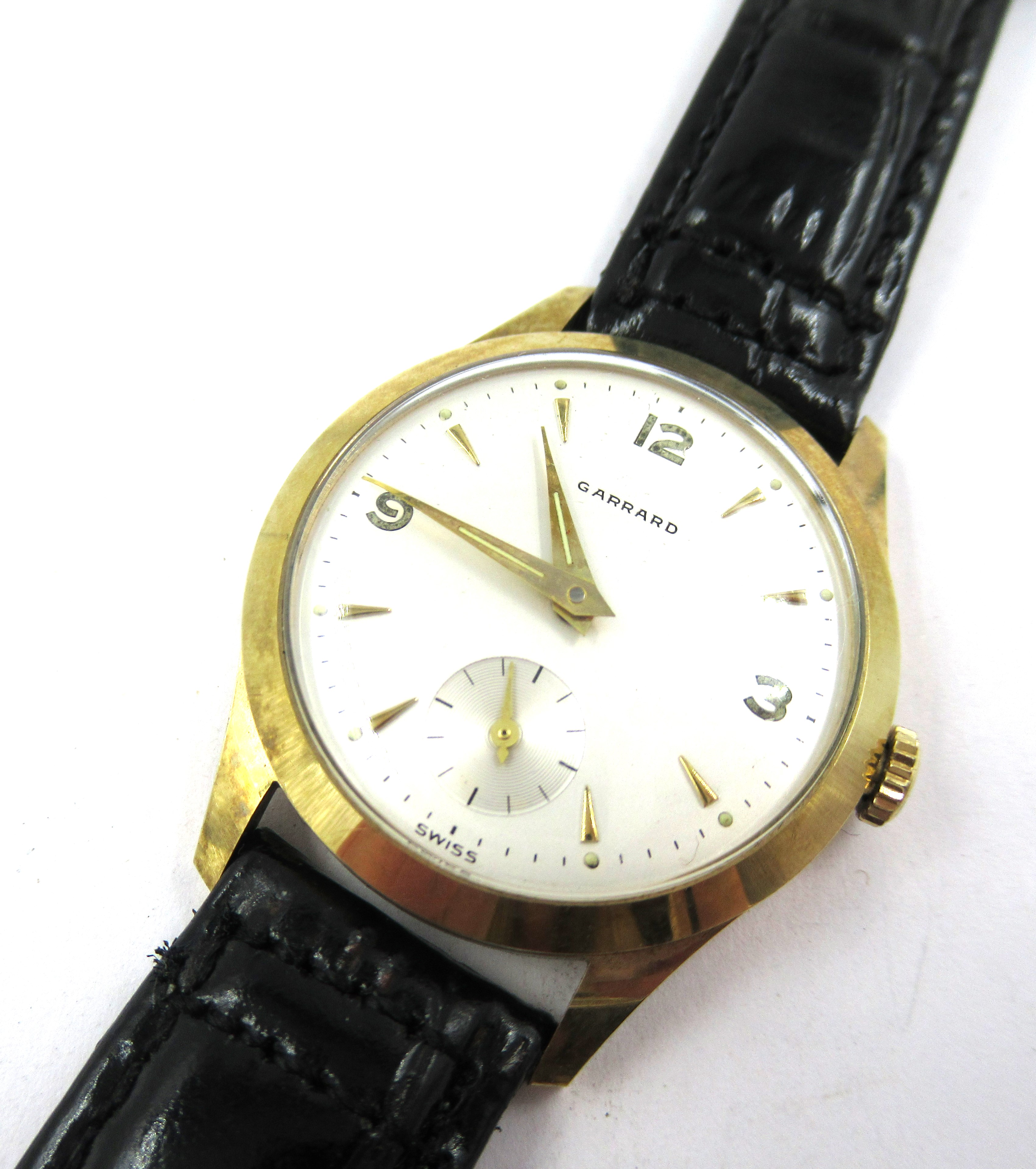 Gentleman's 9ct gold cased wristwatch by Garrards, the silvered dial with Arabic and baton numerals,