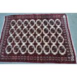 Small Pakistan rug of Turkoman design with four rows of eight gols on an ivory ground with