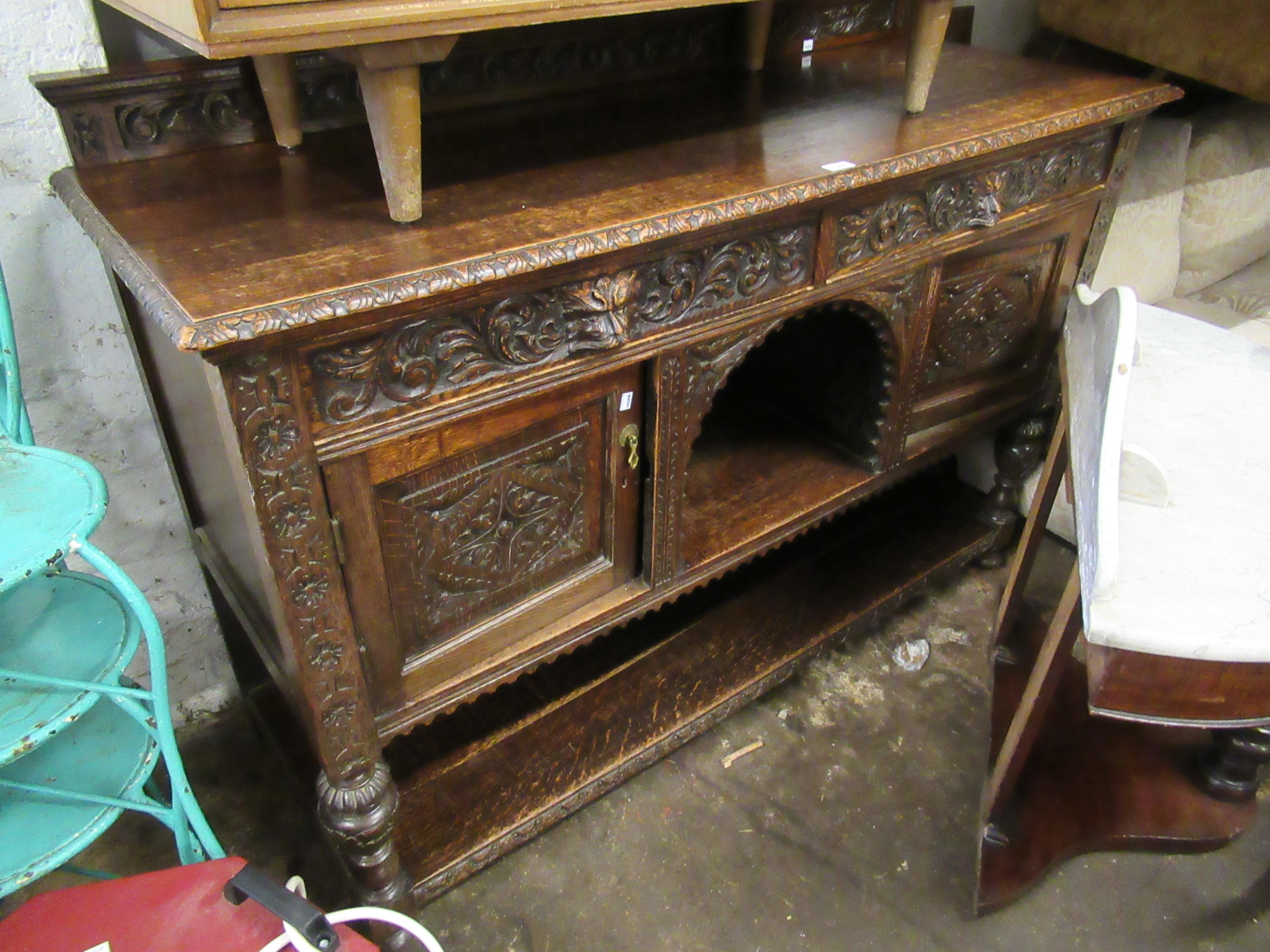 Early to mid 20th Century oak sideboard having galleried back above two long maskhead drawers, two