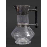 ARTS & CRAFTS CLARET JUG - MAPPIN BROTHERS in the manner of Christopher Dresser, with a glass body