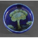 EARLY MOORCROFT BOWL - MOONLIT BLUE a circular bowl painted with trees to the interior and