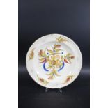 CONTINENTAL FAIENCE CHARGER a tin glazed charger painted with birds, sprigs of flowers and fruit