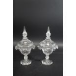 PAIR OF GLASS LIDDED JARS probably 19thc with pointed finials and faceted lids, with an