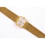 A LADY'S 18CT GOLD SWISS WRISTWATCH BY CONSUL with signed rectangular dial, on a gold mesh