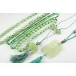 FOUR ASSORTED JADE BEAD NECKLACES together with two carved jade pendants