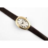 A LADY'S GOLD BAIGNOIRE WRISTWATCH BY CARTIER the signed dial with Roman numerals, with cabochon