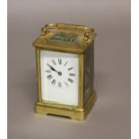 A FRENCH BRASS CARRIAGE CLOCK, the enamelled dial on a brass eight day movement striking half hourly