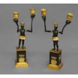A PAIR OF FRENCH EMPIRE STYLE CANDELABRA, 19th century, with Blackamoor figures each holding aloft