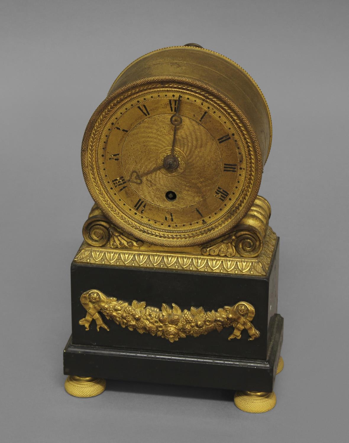 A FRENCH EMPIRE STYLE GILT AND BLACK SLATE MANTEL TIMEPIECE, early-mid 19th century, the 3 1/2" gilt