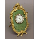A FRENCH ANEROID BAROMETER, the 2 1/4" enamelled dial marked Toricelli, in a scrolling gilt frame