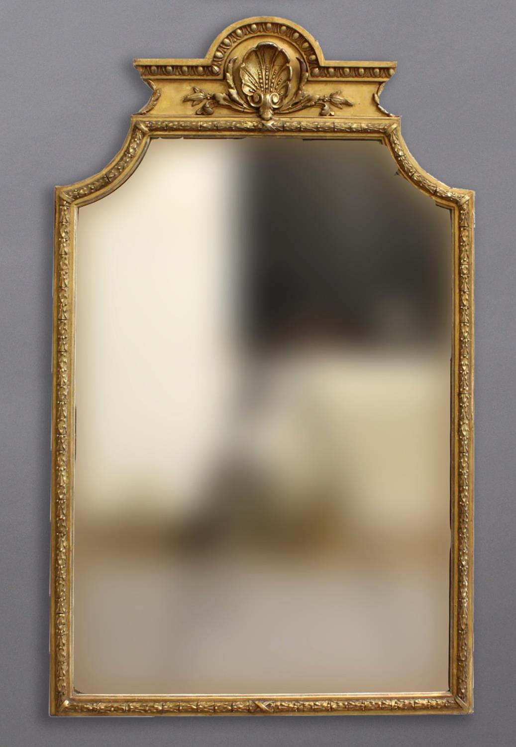 A 19TH CENTURY GILT WOOD WALL MIRROR, of shaped rectangular form, the pediment with shell and leaf