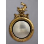 A 19TH CENTURY GILTWOOD CONVEX MIRROR, surmounted by a mythical seahorse on a rocky outcrop above