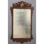 A 19TH CENTURY MAHOGANY FRET CARVED WALL MIRROR, the rectangular plate with parcel gilt border,