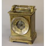 A VICTORIAN BRASS CASED MANTLE CLOCK AND BAROMETER, the circular dial with recessed centre with