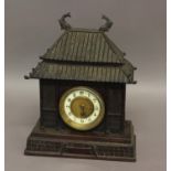 A JAPANESE STYLE MANTEL CLOCK, the 3 3/4" ivorine and brass dial set in a bronzed case in the form