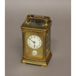 A FRENCH BRASS CARRIAGE CLOCK, 19th century, the gilt face with enamelled dial and subsidiary