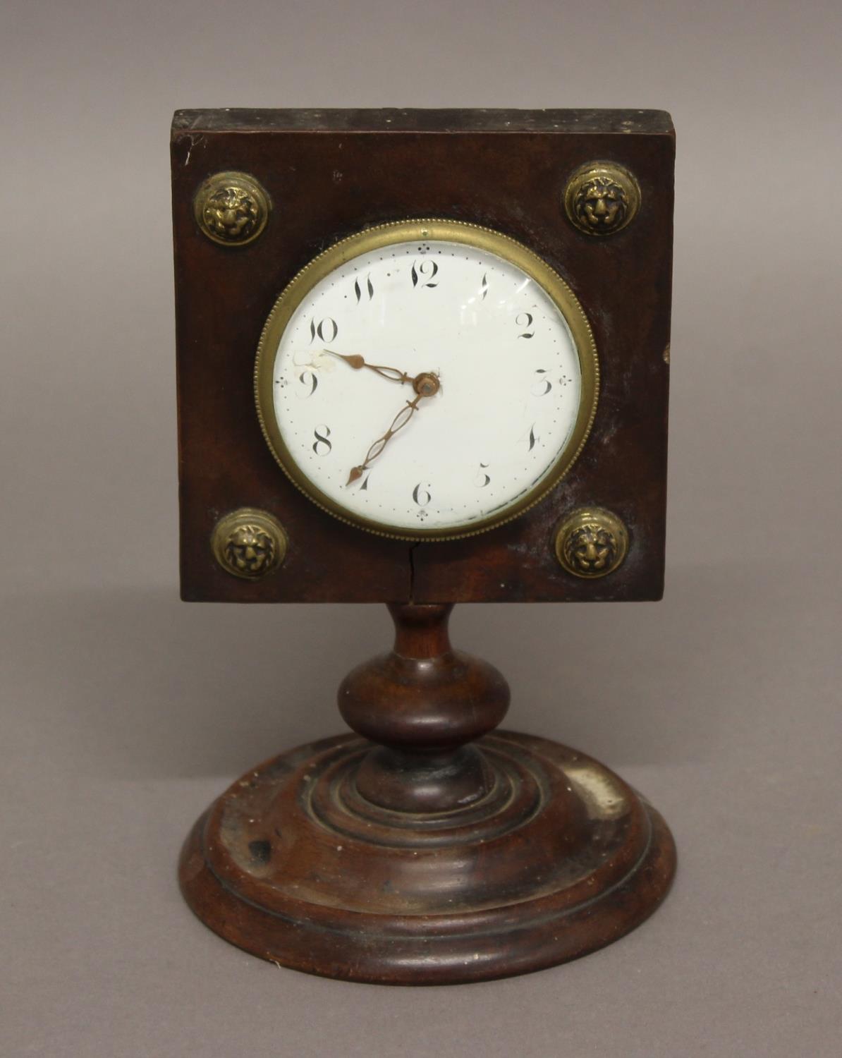 A 19TH CENTURY MAHOGANY TIMEPIECE, the 2 3/4" enamelled dial set into a square case with brass