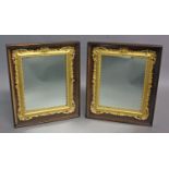 A PAIR OF VICTORIAN GILT AND ROSEWOOD FRAMED MIRRORS, with rectangular carved and moulded gilt