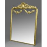 A GILT OVERMANTEL MIRROR, the rounded rectangular plate below a shell and pierced wreath surmount