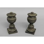 A PAIR OF CAST AND PATINATED BRONZE URNS AND COVERS, the bronze urn shaped vases with cast