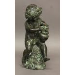 A BRONZE STUDY OF A BACCHANALIAN CHERUB, 19th century, modelled seated on a rocky outcrop picking