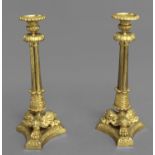 A PAIR OF EARLY 19TH CENTURY GILT BRASS CANDLESTICKS, each with detachable sconces with moulded