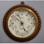 AN OAK CASED ANEROID BAROMETER, the 10" enamelled dial signed Robinson & Co, The Square, Shrewsbury,